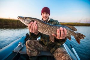 A fisher holding a big fish